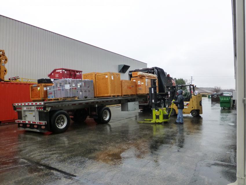 IDP engineers Josh Goetz and Jay Johnson unload a flatbed truck full of drilling equipment