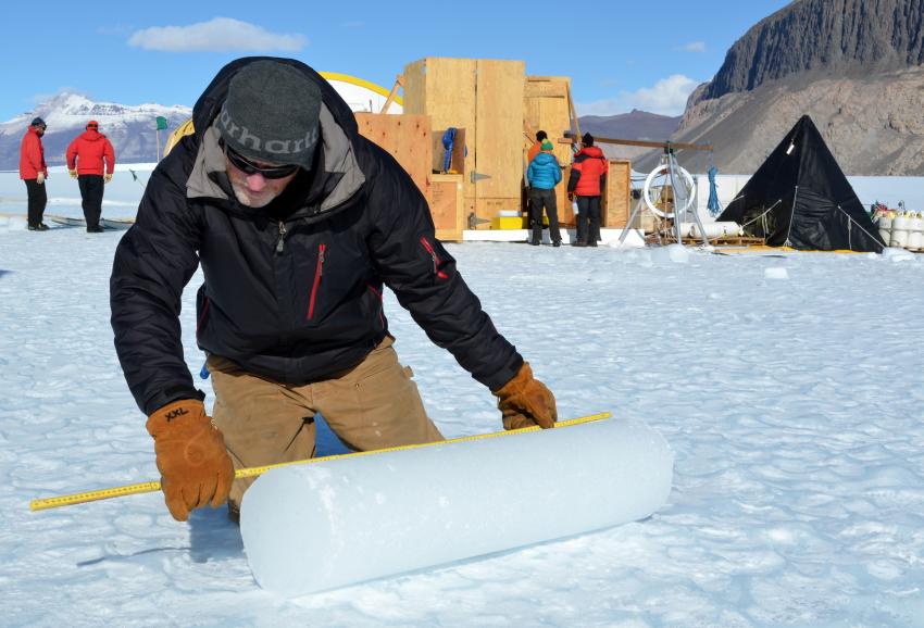 IDP driller Mike Jayred measures an ice core atop of Taylor Glacier during the 2013/14 Antarctic field season