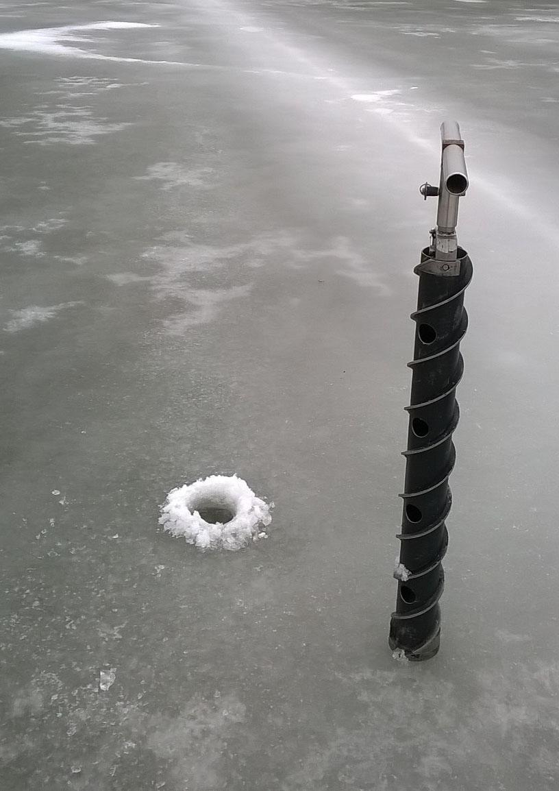 A SIPRE hand auger is used on an ice-covered northern U.S. temperate lake