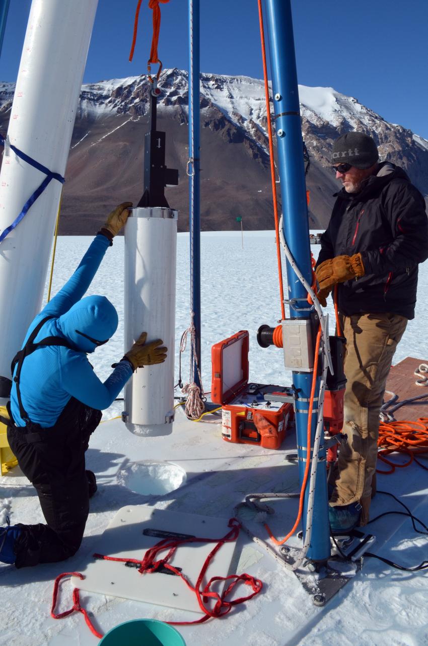 Scientist Michael Dyonisius assists IDDO driller Mike Jayred in drilling an ice core with the Blue Ice Drill on Taylor Glacier