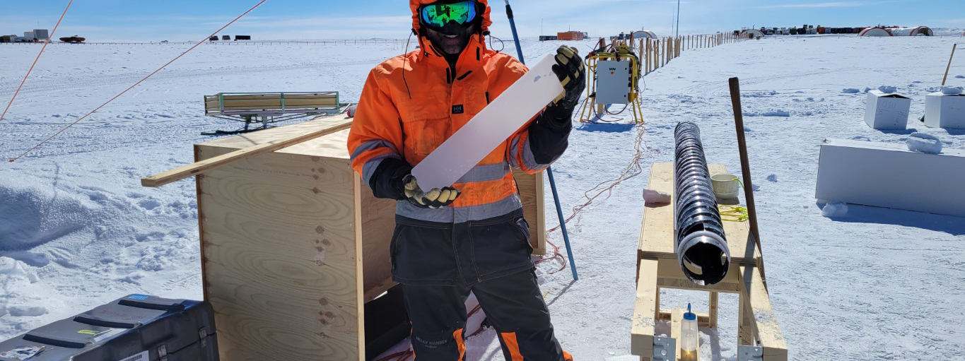 Jay Johnson holds an ice core that he drilled at Dome C, Antarctica.