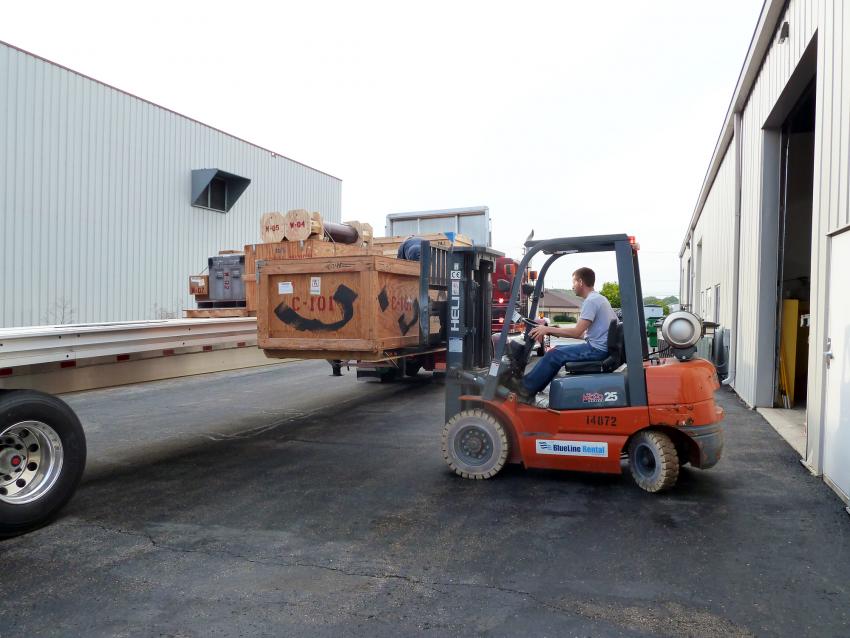 Jay Johnson loads the 53-foot Conestoga trailer with cargo