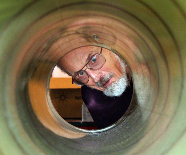 Professor Emeritus Bentley inspects the barrel of the Blue Ice Drill, designed and built by the UW-Madison Ice Drilling Design and Operations team