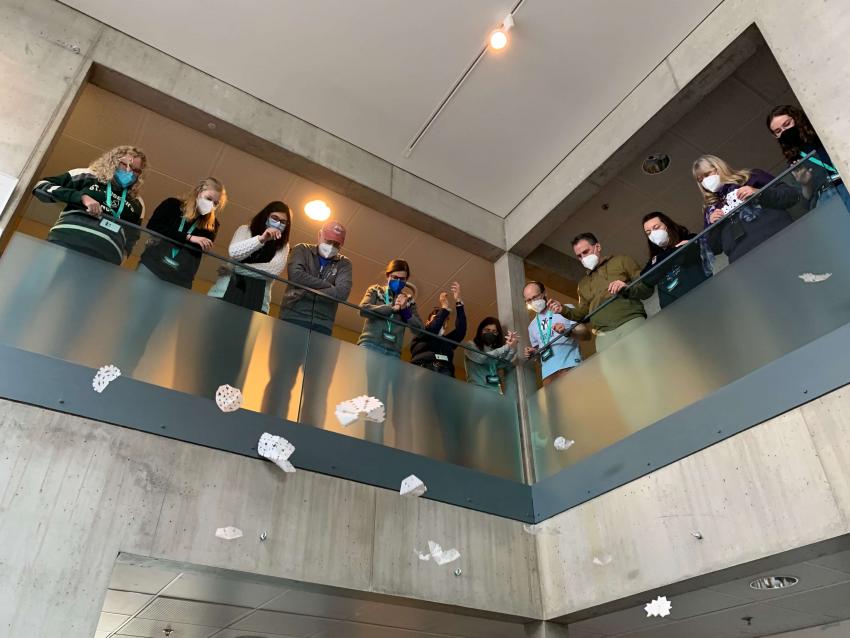 Educators at the Polar Educators’ International (PEI) 5th international conference dropping paper snowflakes from the second-floor balcony to calculate fall rate