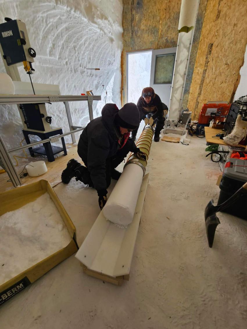 PI Nathan Chellman’s science team pushes a core out of the barrel of the Blue Ice Drill